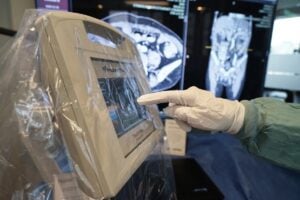 a hand touching a screen on a hospital environment